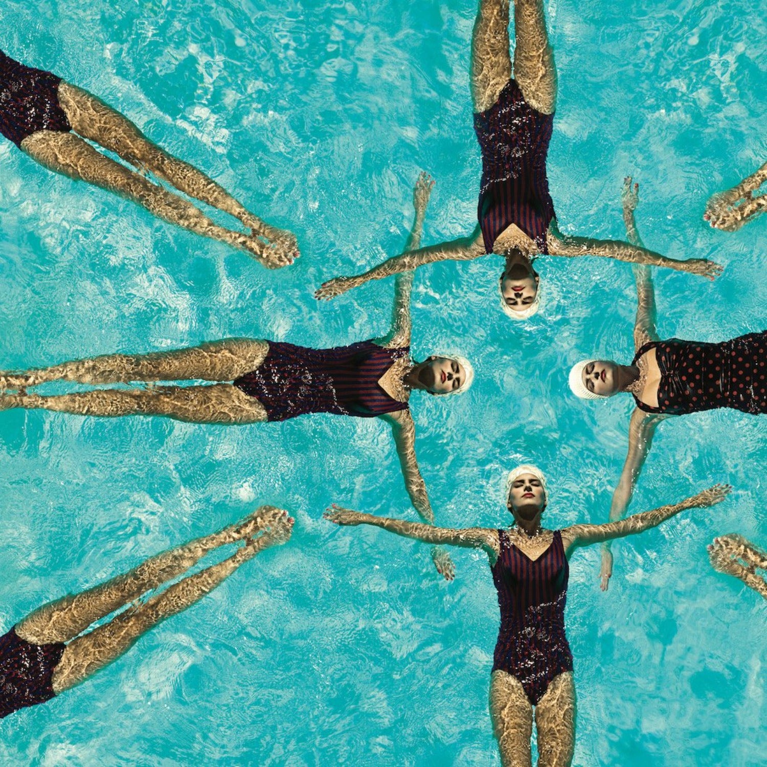 women in one pieces and swim caps synchronized swimming on a sunny day fine art print by Gabor Jurina